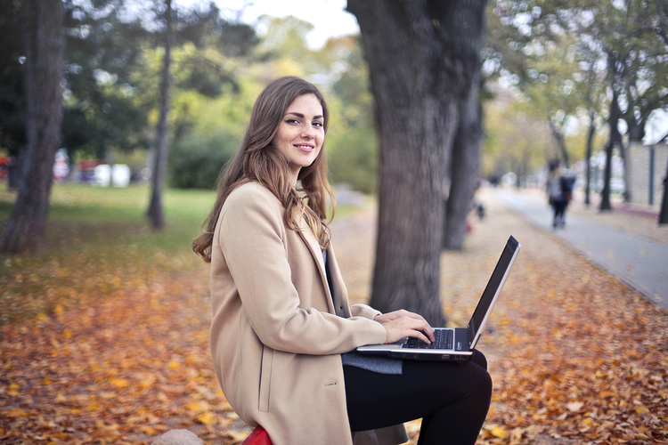 Canva   Joyful Confident Woman Using Netbook In Park Blog